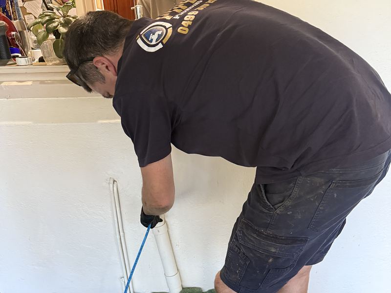 Craig clearing a blocked drain with the jetter hose and reel